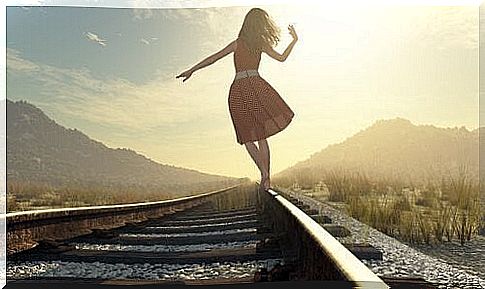 Woman walking on railway.