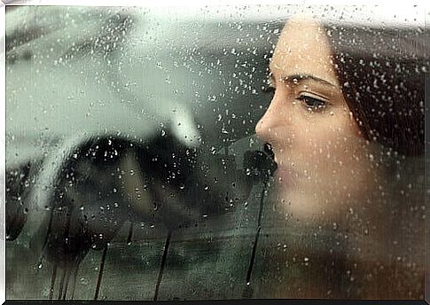 Woman by rainy window