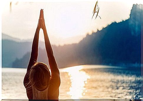 Woman doing yoga pose Urdhva Hastasana