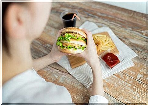 Woman eating hamburger