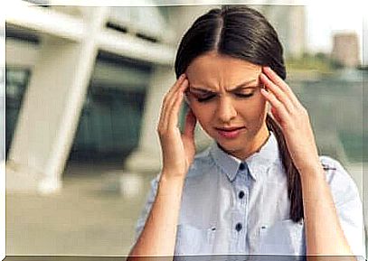 Stressed woman with her hands on her temples