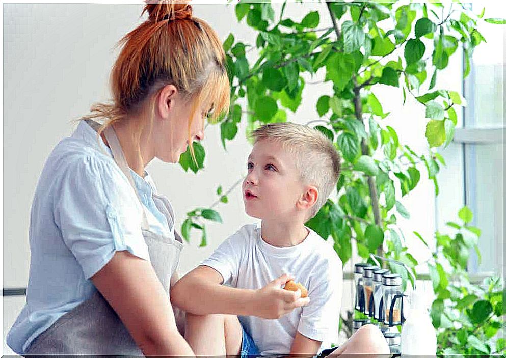 A woman talking to a boy.