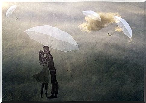 Couple kissing among umbrellas