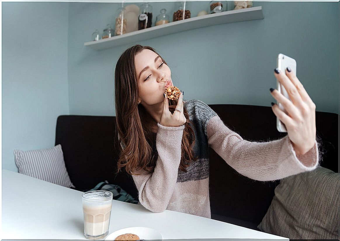 Girl having coffee and checking her mobile