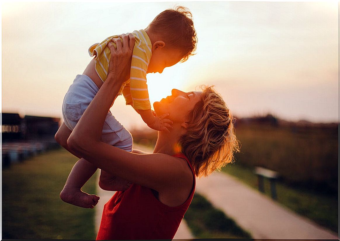 Mother holds her son in her arms