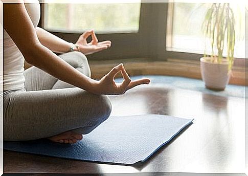 Woman meditating in living room