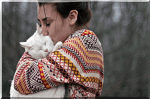 Woman hugging cat