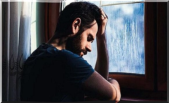 Sad man at window