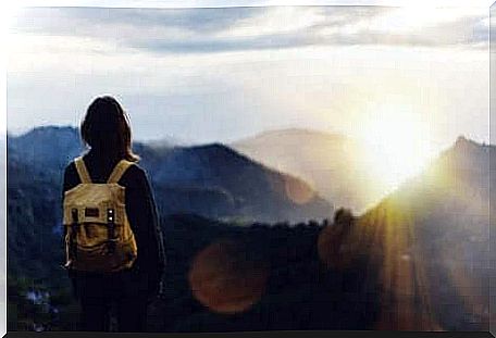 A backpacker on top of a mountain.