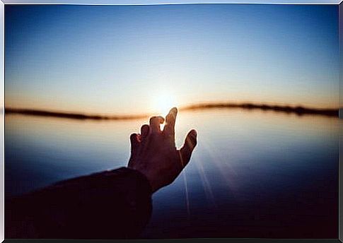 Hand in sunrise